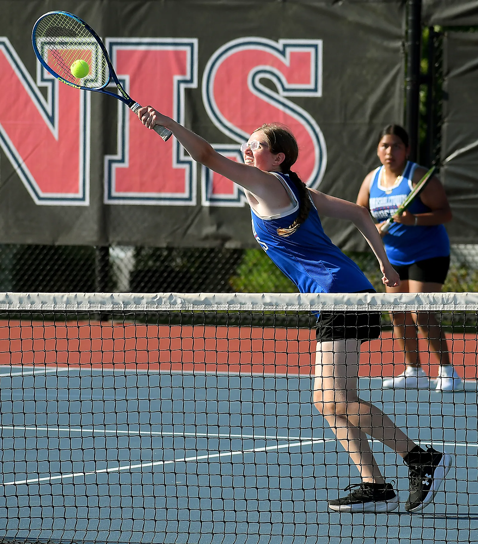 Marshalltown Girls Tennis coach James Christensen talking to players on court during hot triangular meet